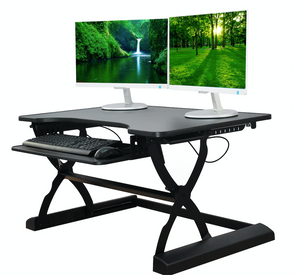 A standing desk with computer monitors on it